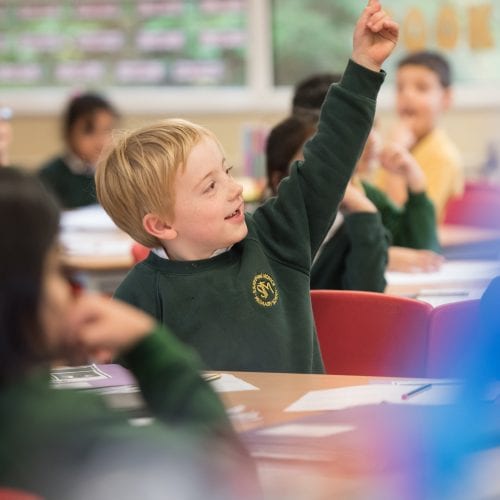 child with hand up