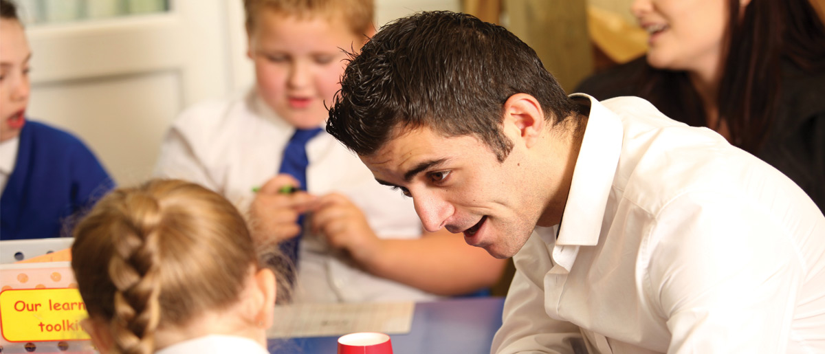 teacher talking to school pupils