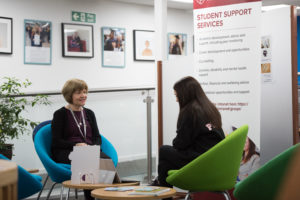 a member of the student support team speaking one-to-one with a student