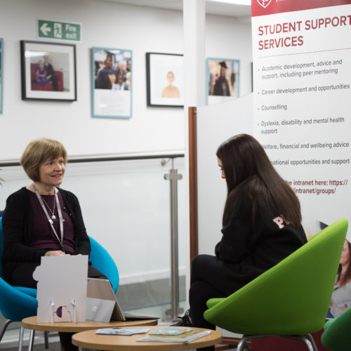 a member of the student support team speaking one-to-one with a student