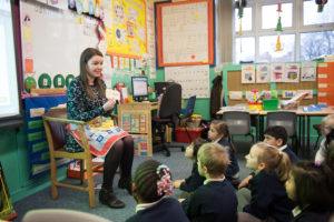 Primary school teacher talking to pupils