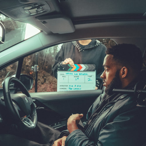 Jamaal filming for BBC short film sat in car