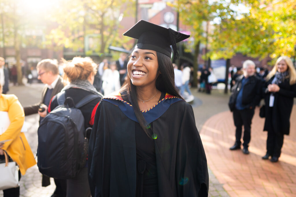 Newman graduate smiling