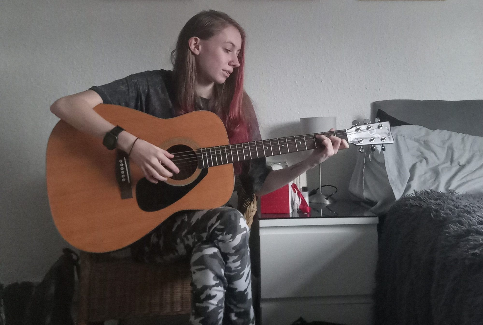 Studies in Primary Education Student Charlotte Quarry playing guitar