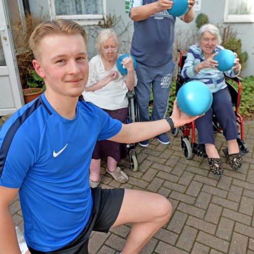 Sport student Joab Wheatley working at a care home with elderly residents helping them to keep fit