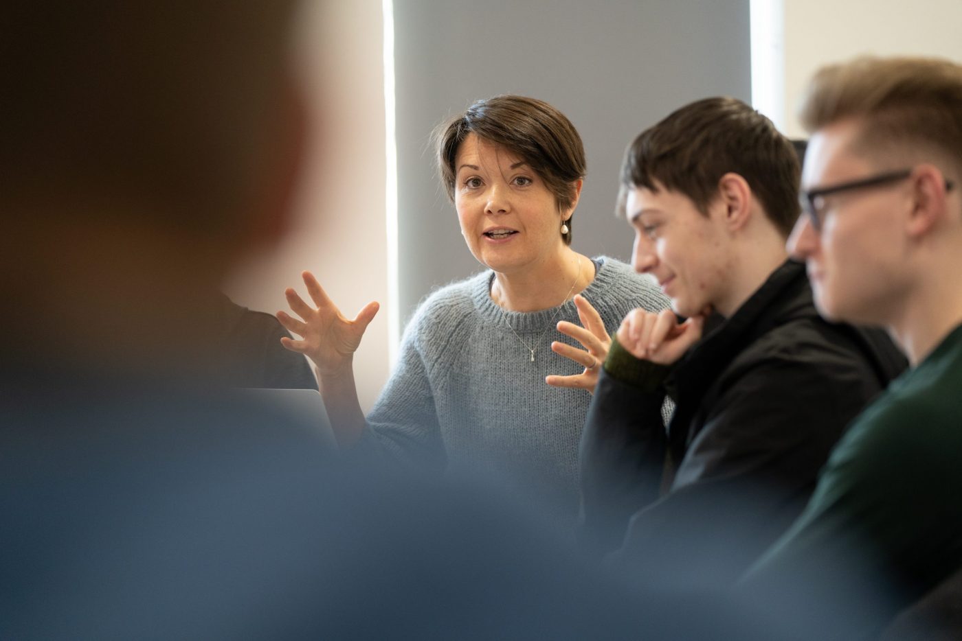 Lecturer talking to applied humanities students