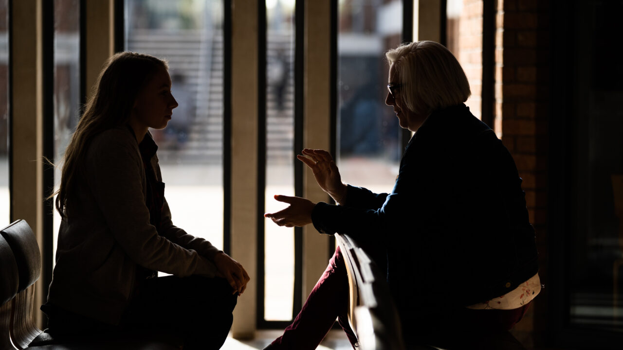 chaplaincy lecturer talking to student