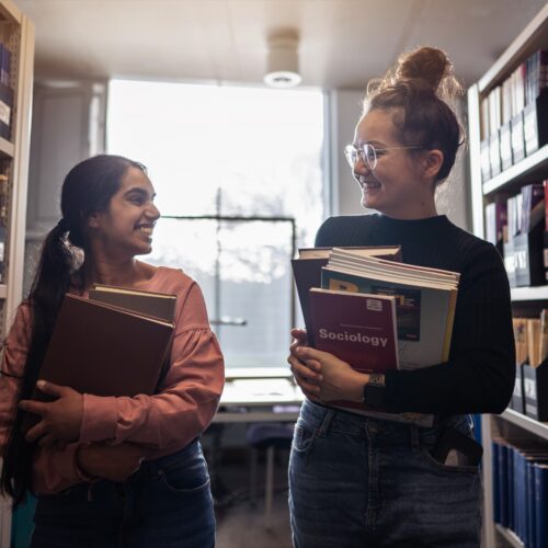 Students talking to each other in Library