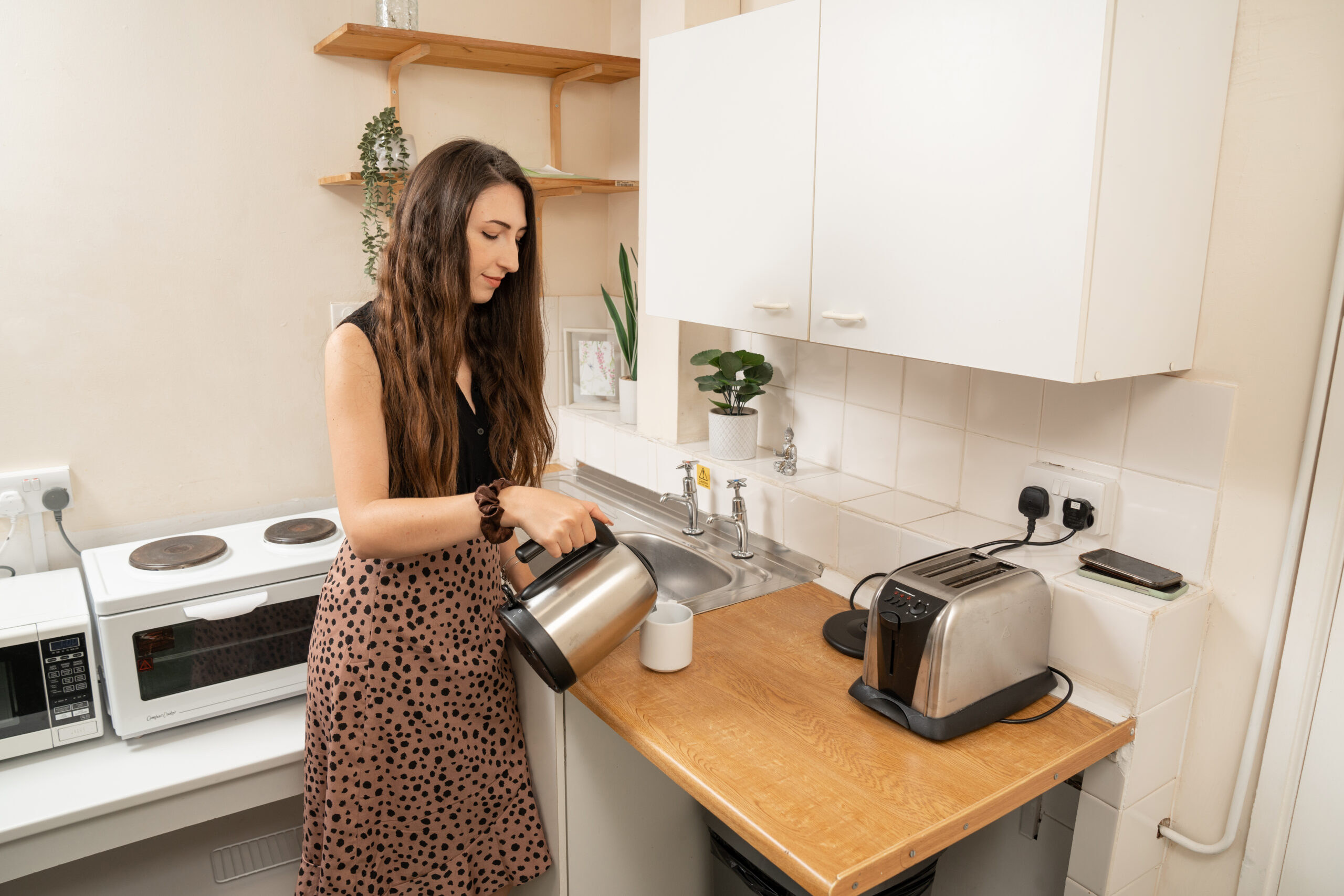 student using the kitchen in accommodation