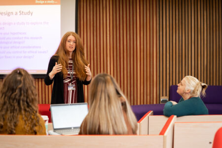 Psychology lecturer with students in lesson