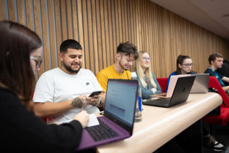 Students in lecture with their laptops