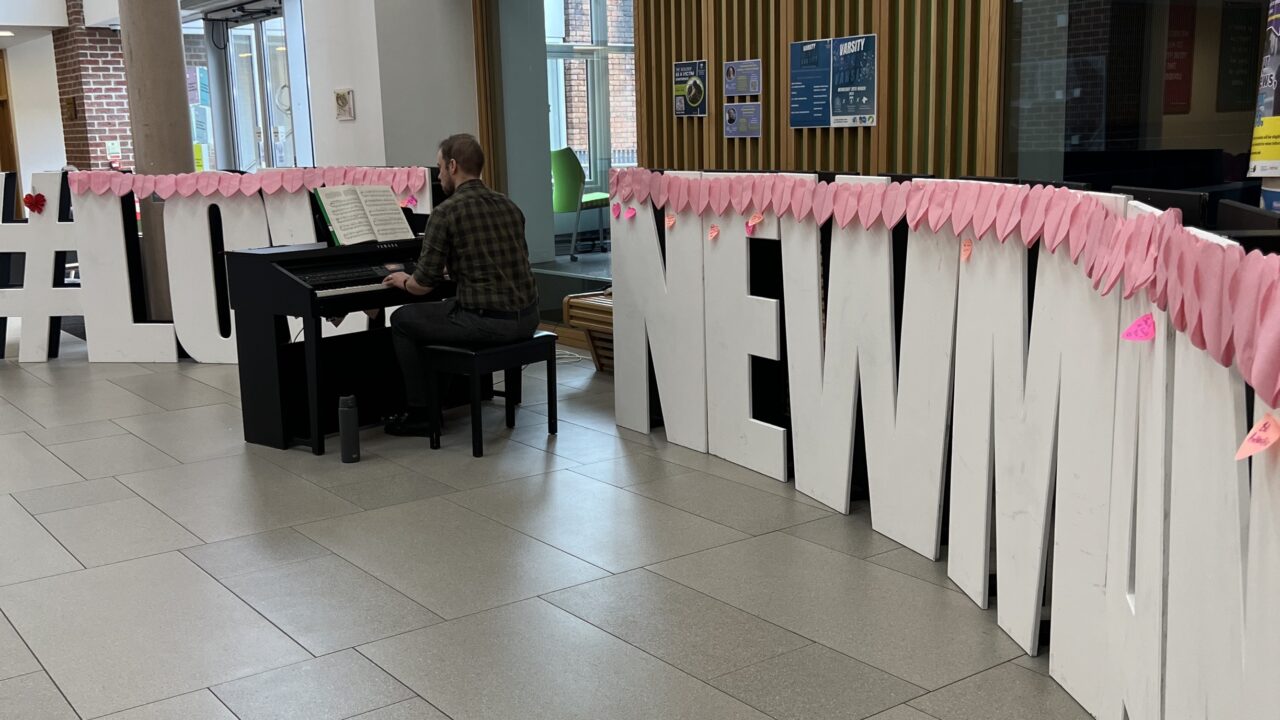 Playing the piano at Love Newman