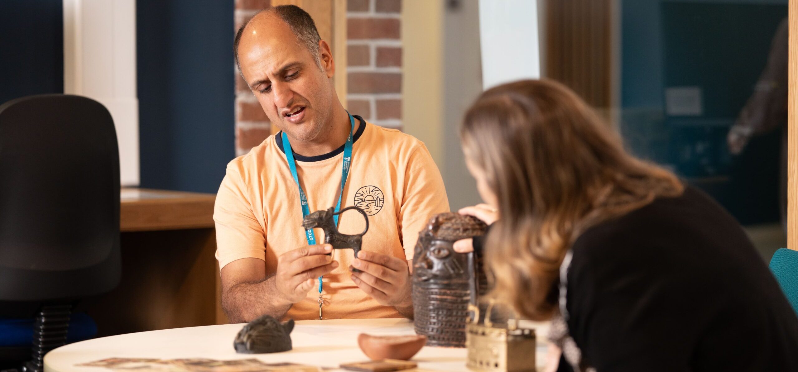 Two history students looking at artefacts