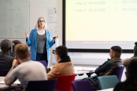 Business Management Lecturer in lesson with students