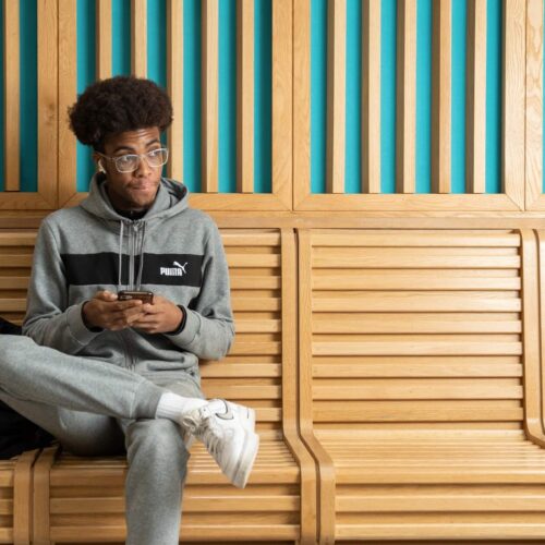 Student sitting down on mobile phone