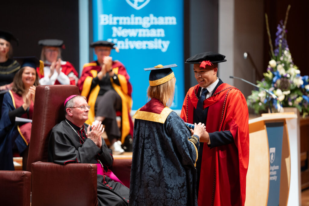 Joe Fraser receiving honorary degree from VC on stage