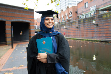 2024 graduate outside ICC near canal in Birmingham