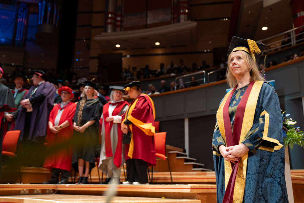 VC on stage at graduation