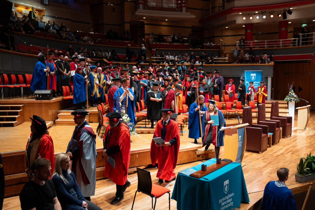 Staff leaving graduation stage