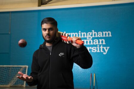 Sports student with cricket bat and ball