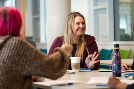 Students studying and talking around a table