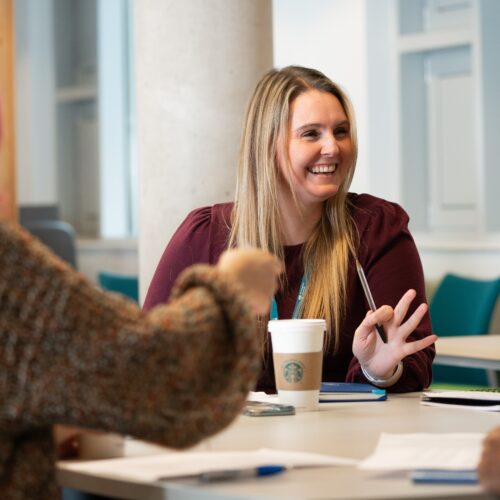 Students studying and talking around a table