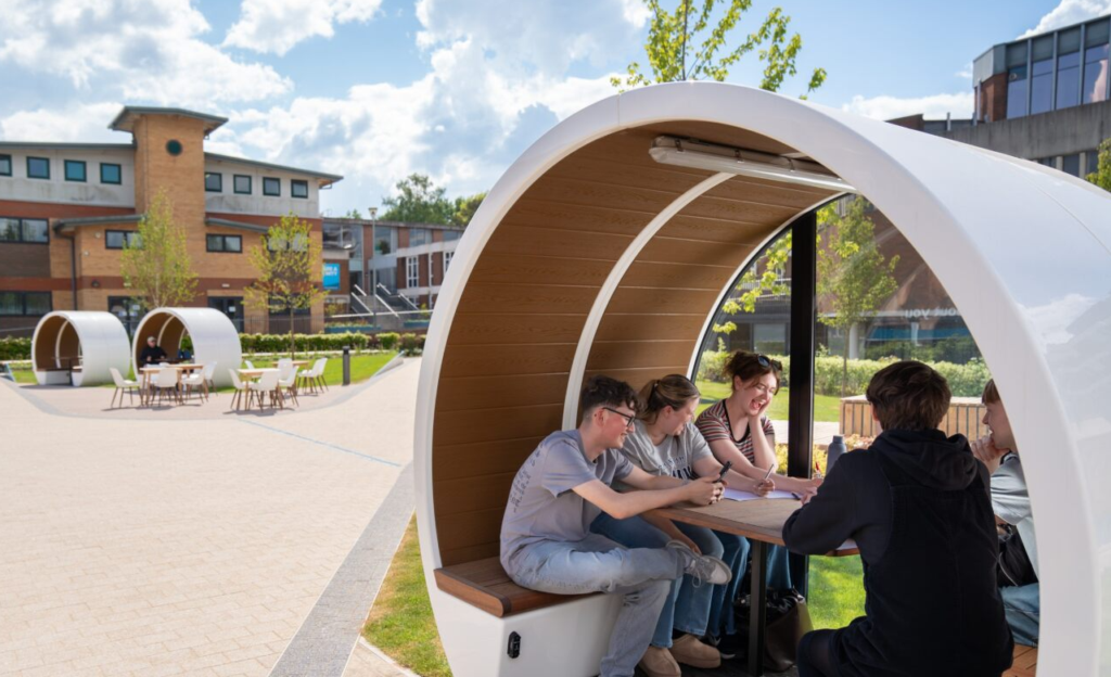 Students relaxing in pods located in Ryland Quad, Birmingham Newman University