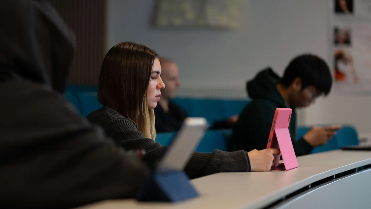 Student in lecture with laptop