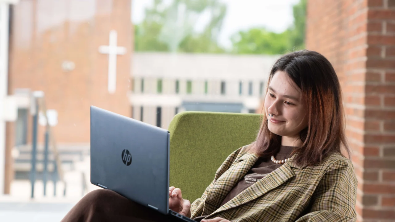 Student sitting down with laptop