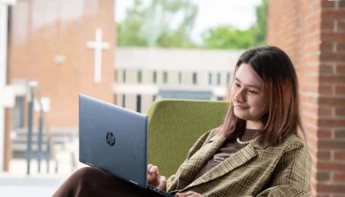 Student sitting down with laptop